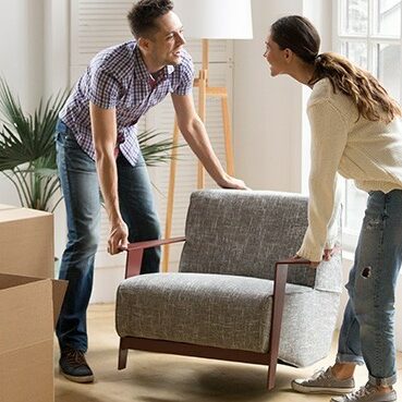 Couple moving sofa | Derailed Commodity Flooring & Furniture